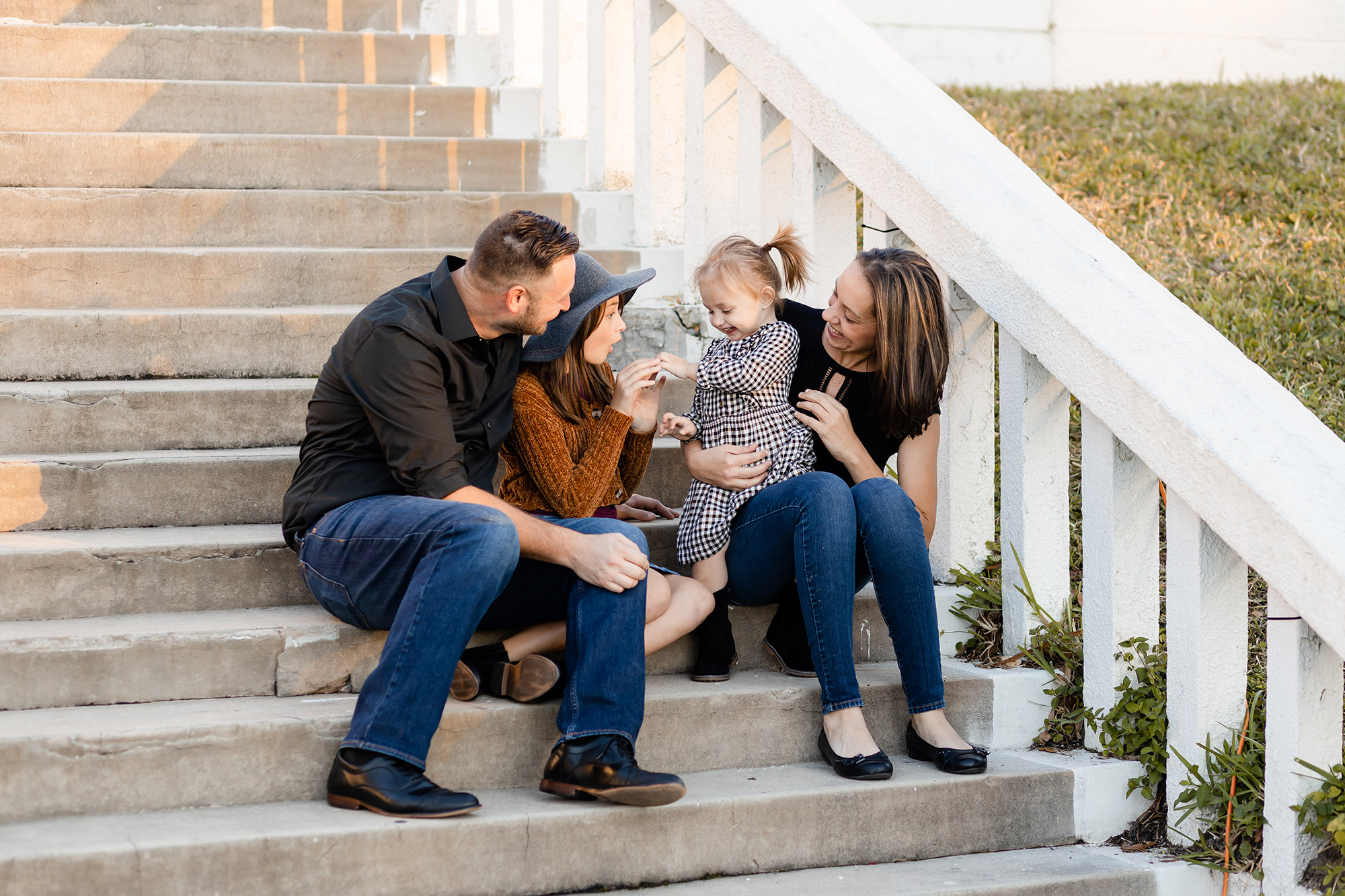 happy family smilings on the steps in downtown Tarpon Springs