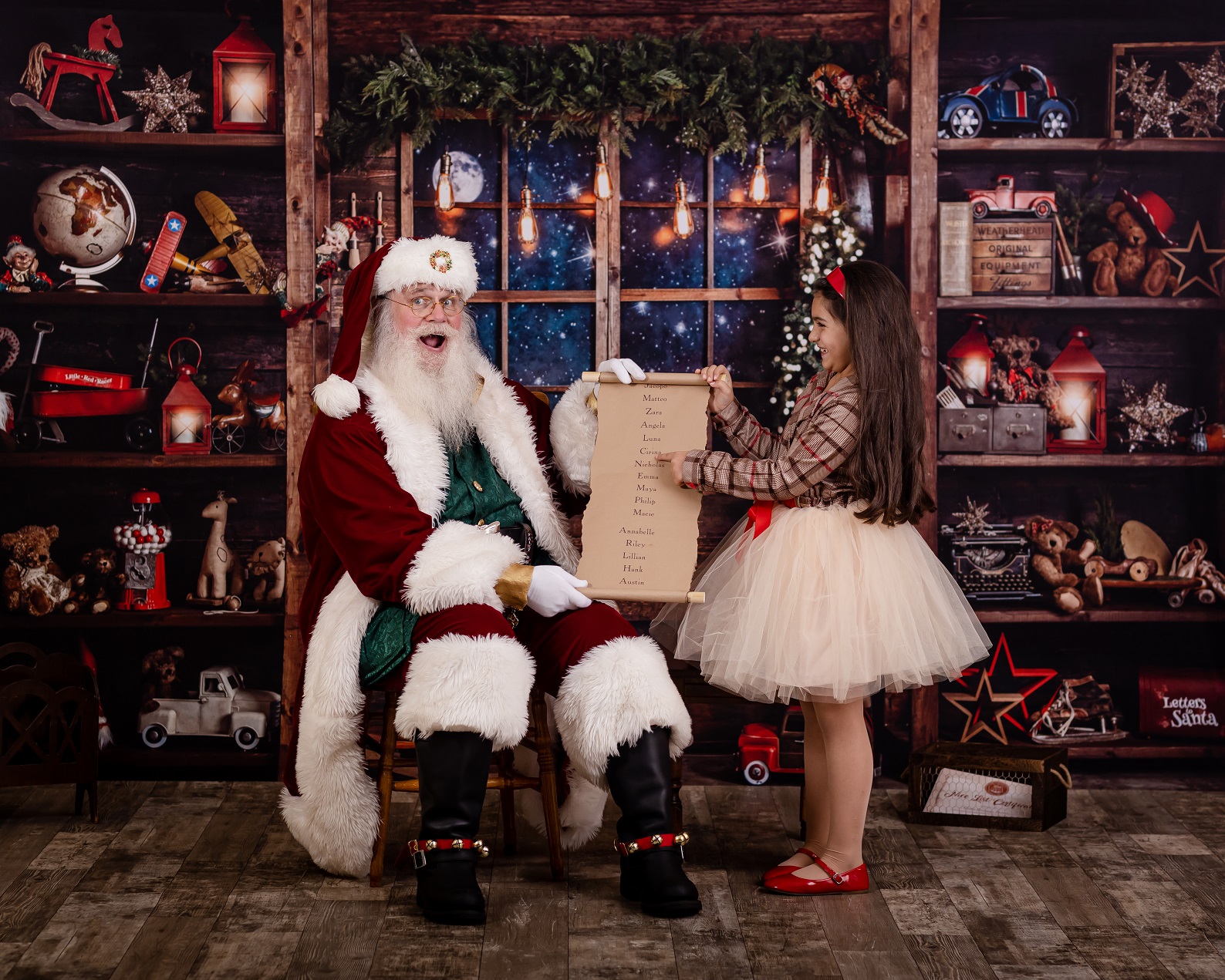 girl pointing to the nice list with santa claus
