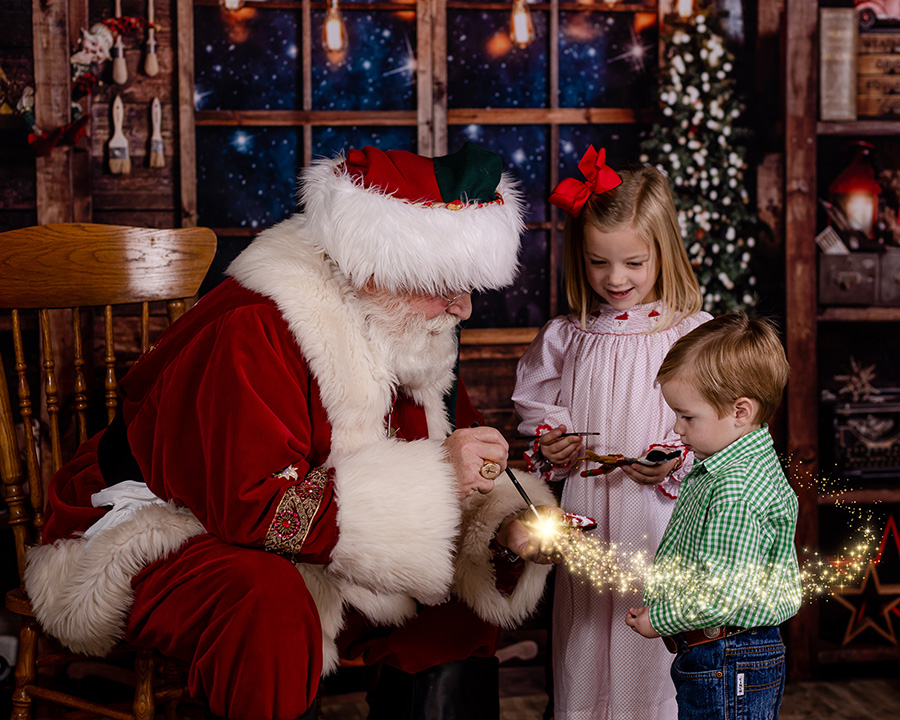 two young children paiting with santa